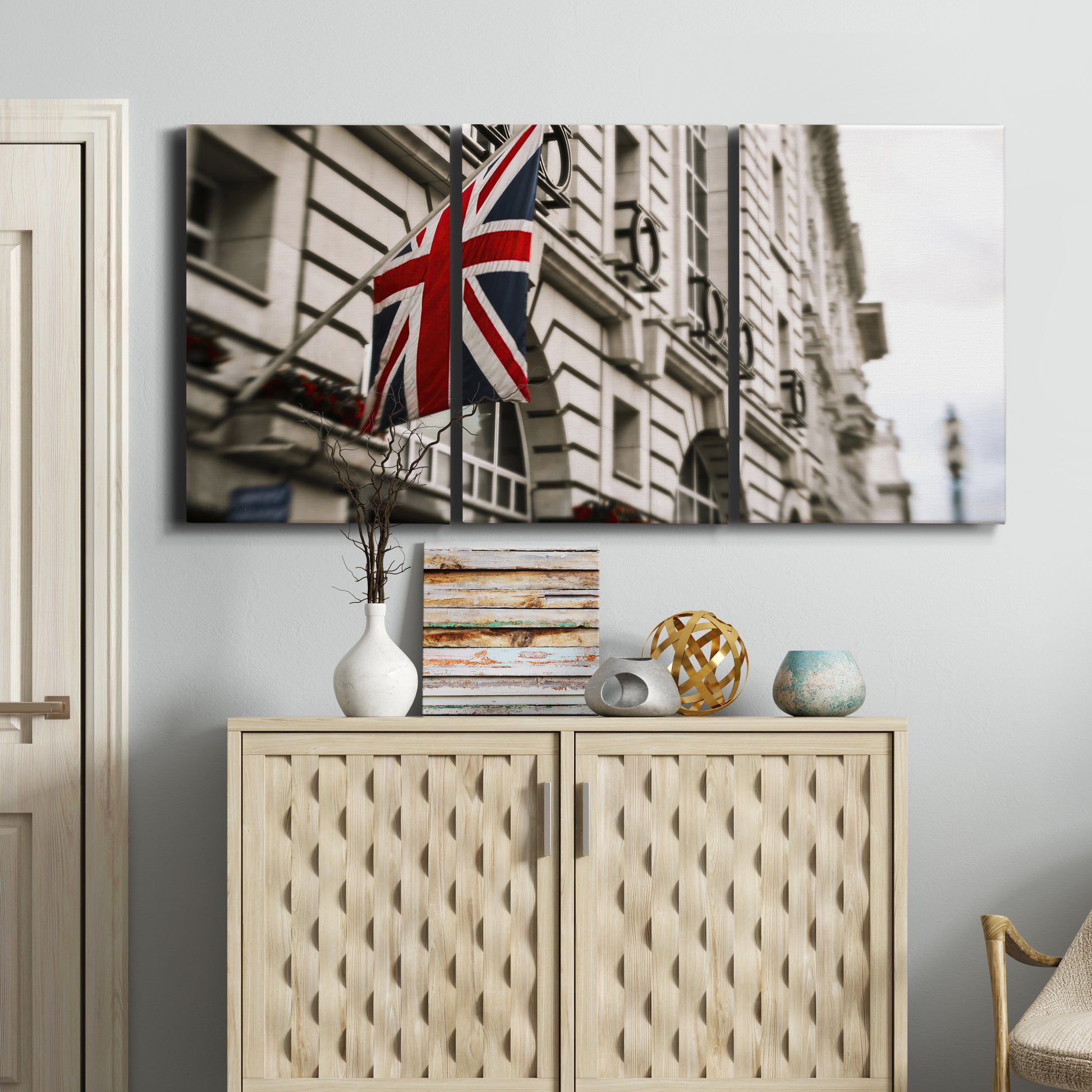 Three-panel canvas wall art featuring london street scene photograph, displayed above a cabinet in an entryway.
