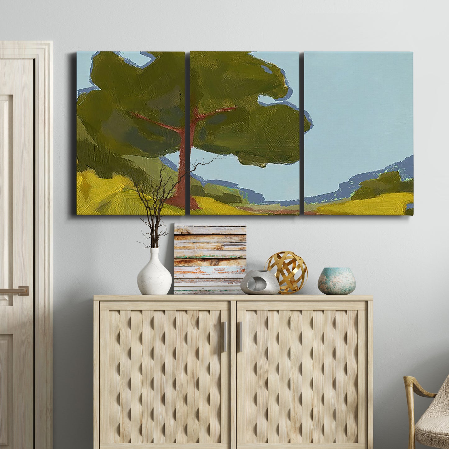 Three-panel canvas wall art featuring sunlit public park landscape view, displayed above a cabinet in an entryway.