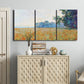 Three-panel canvas wall art featuring oat field with scattered poppies, displayed above a cabinet in an entryway.
