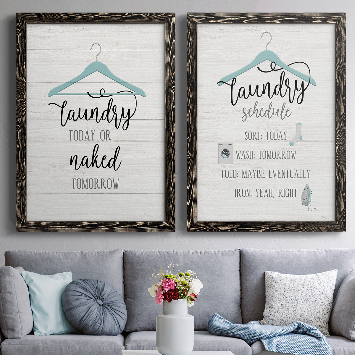 Set of two black barnwood framed canvas prints depicting paired rustic typographic wall art with hand-lettered phrases, socks hangers and laundry symbols on linen texture above a sofa in a contemporary living room.