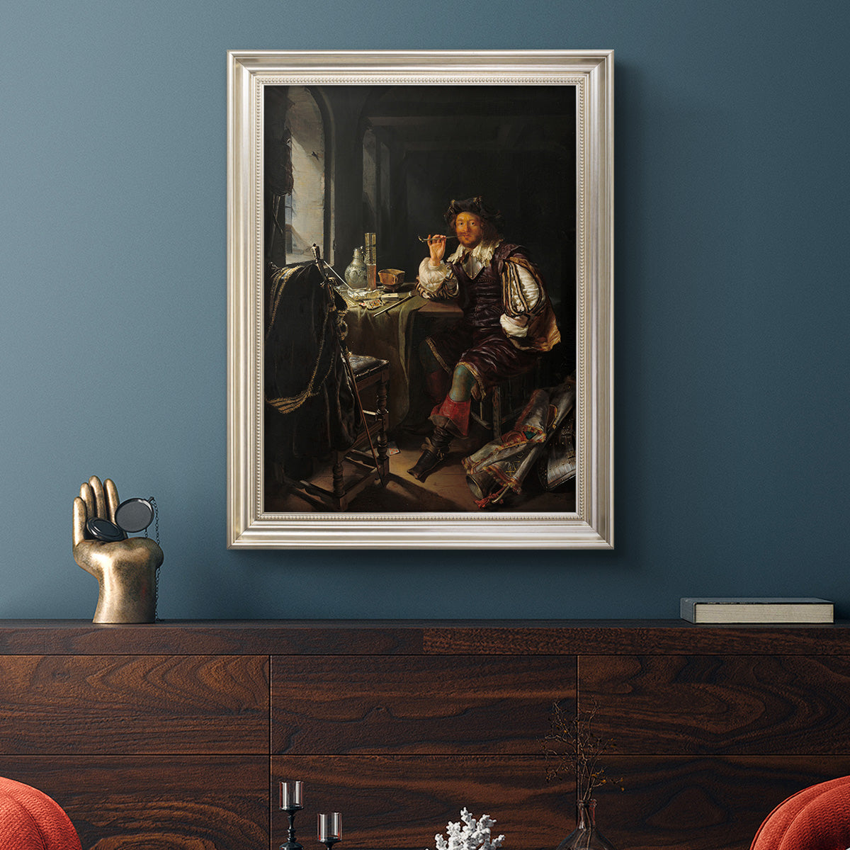 Classical portrait of a soldier smoking a pipe by Frans van Mieris the Elder in an ornate champagne frame displayed in a dark-toned interior setting.