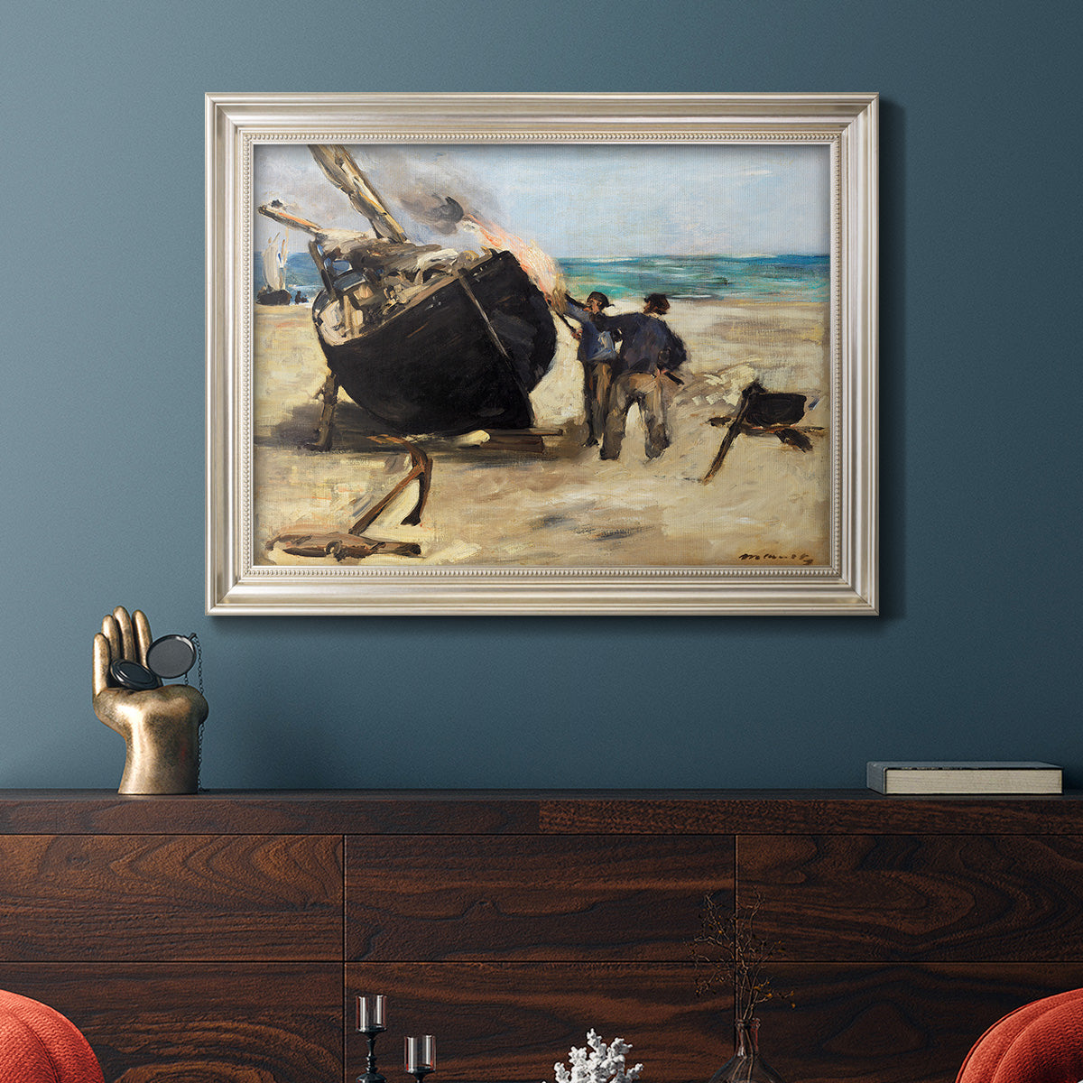 Impressionist nautical work scene by Édouard Manet in an ornate champagne frame displayed in a dark-toned interior setting.