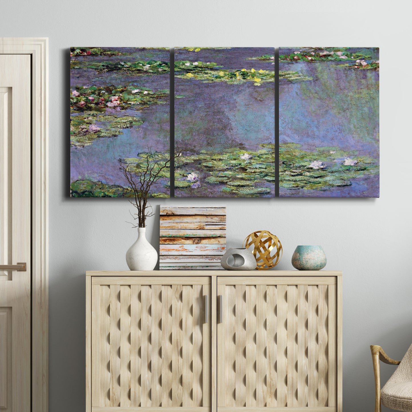 Three-panel canvas wall art featuring purple haze water lily pond, displayed above a cabinet in an entryway.