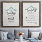 Set of two walnut barnwood framed canvas prints depicting paired rustic typographic wall art with hand-lettered phrases, socks hangers and laundry symbols on linen texture above a sofa in a contemporary living room.