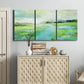 Three-panel canvas wall art featuring gentle stream winding through trees, displayed above a cabinet in an entryway.