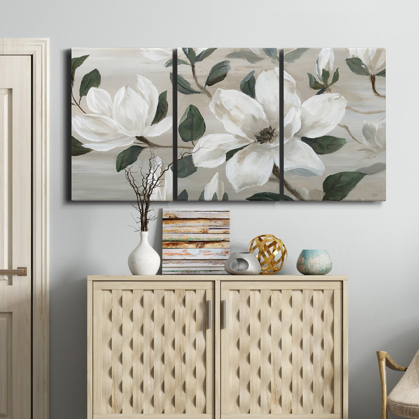 Three-panel canvas wall art featuring soft southern floral charm, displayed above a cabinet in an entryway.