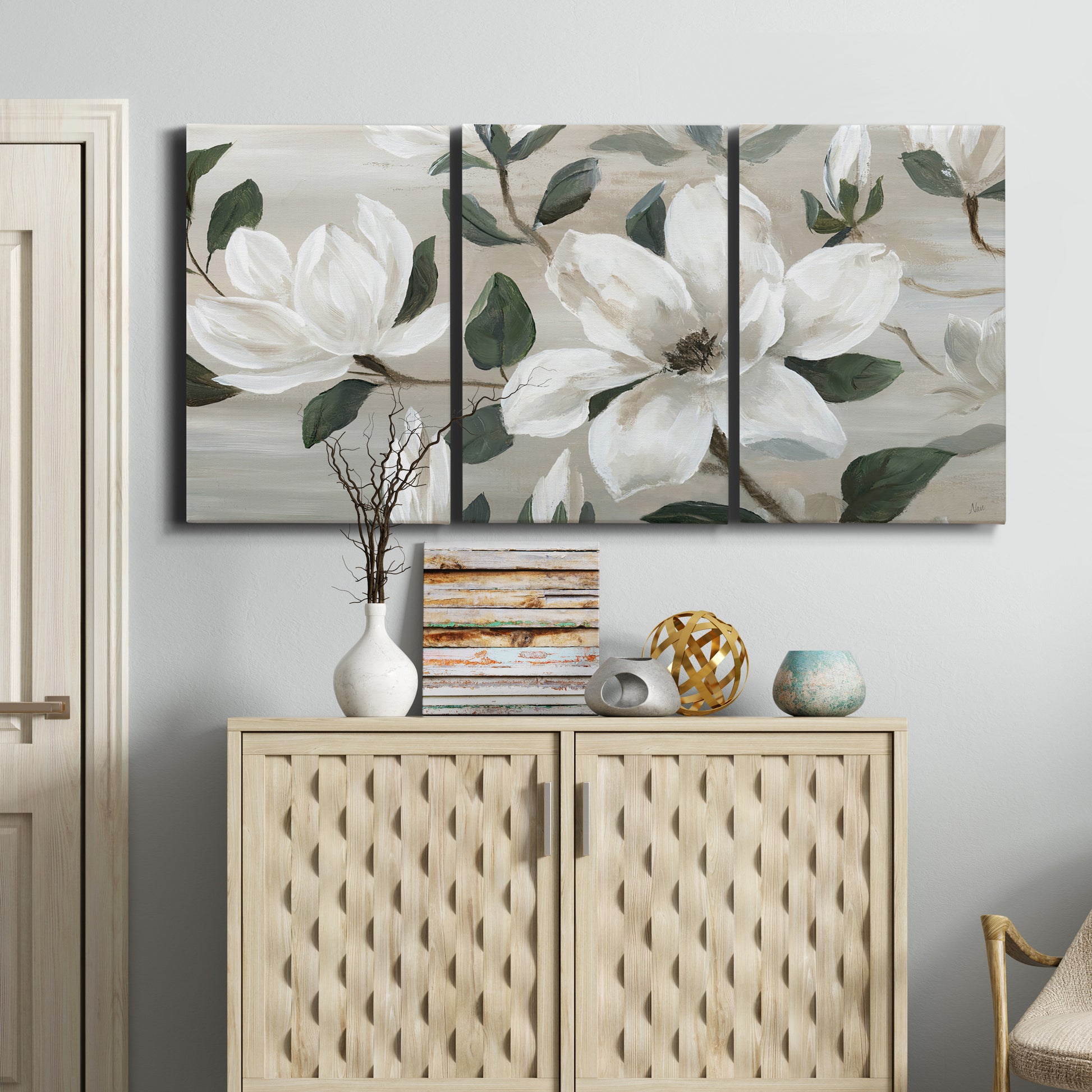 Three-panel canvas wall art featuring soft southern floral charm, displayed above a cabinet in an entryway.
