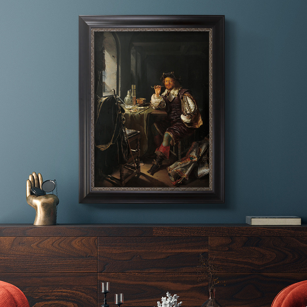 Classical portrait of a soldier smoking a pipe by Frans van Mieris the Elder in an ornate black frame with gilded inner detail displayed in a dark-toned interior setting.