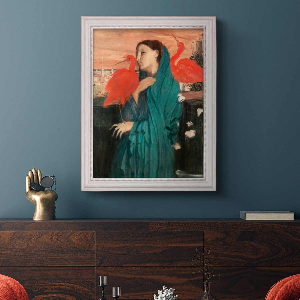 Impressionist portrait of a young woman with an ibis by Edgar Degas in an ornate weathered white frame displayed in a dark-toned interior setting.