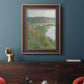 Impressionist landscape view of Vétheuil by Claude Monet in an ornate bronzed mahogany wood frame displayed in a dark-toned interior setting.