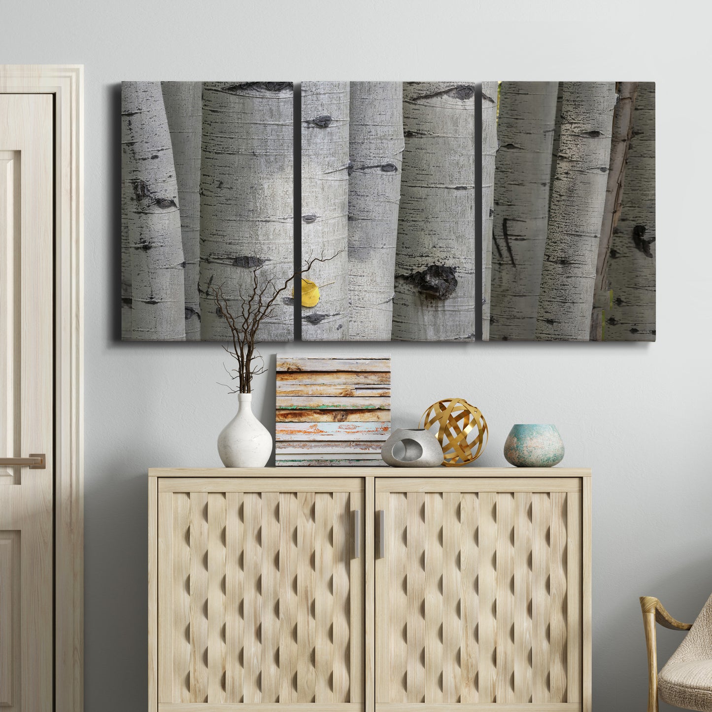 Three-panel canvas wall art featuring close up tree bark texture photograph, displayed above a cabinet in an entryway.