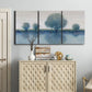 Three-panel canvas wall art featuring calm afternoon river reflection, displayed above a cabinet in an entryway.