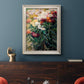 Impressionist garden floral painting by Gustave Caillebotte in an ornate champagne frame displayed in a dark-toned interior setting.