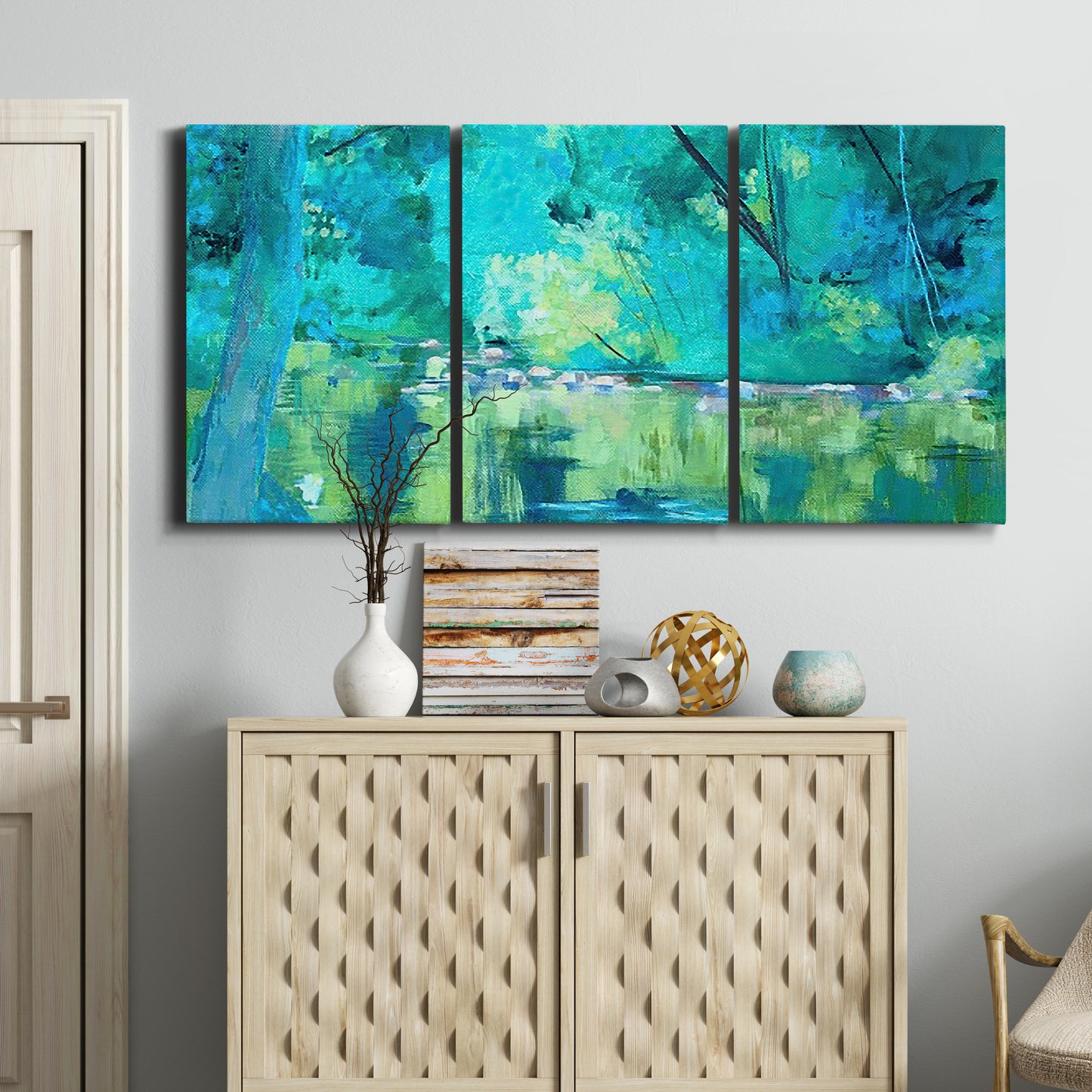 Three-panel canvas wall art featuring abstract river composition with movement, displayed above a cabinet in an entryway.