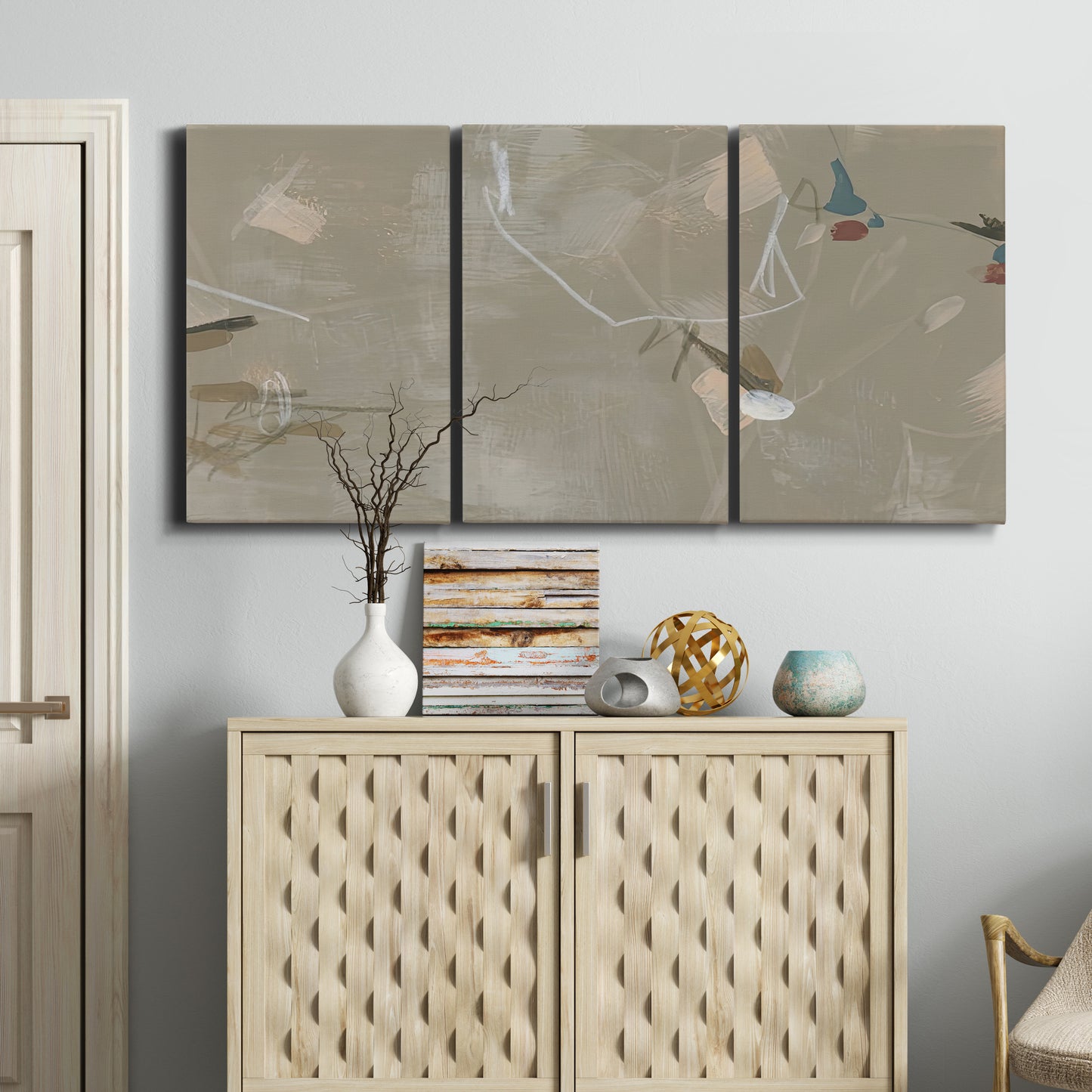 Three-panel canvas wall art featuring mid century terrazzo inspired abstraction, displayed above a cabinet in an entryway.