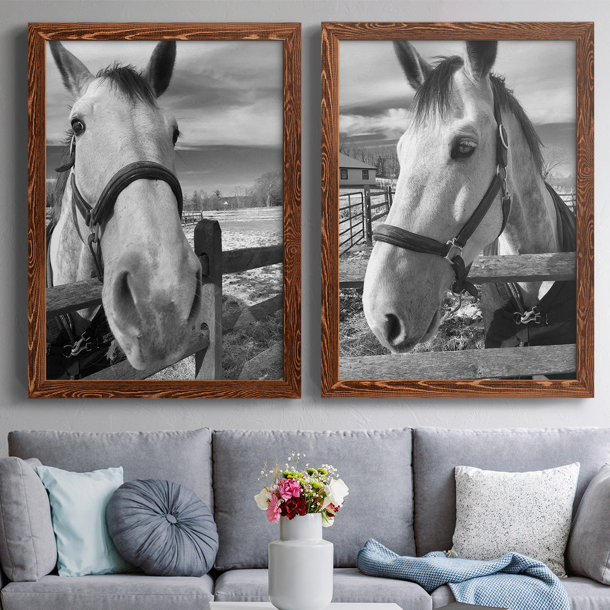 Set of two maple barnwood framed canvas prints depicting paired modern equestrian photography with bridled faces, wooden rails, and softly blurred farm backgrounds above a sofa in a contemporary living room.
