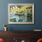Impressionist riverside leisure scene by Claude Monet in an ornate champagne frame displayed in a dark-toned interior setting.