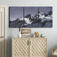 Three-panel canvas wall art featuring moonlit mountain peaks under night sky, displayed above a cabinet in an entryway.