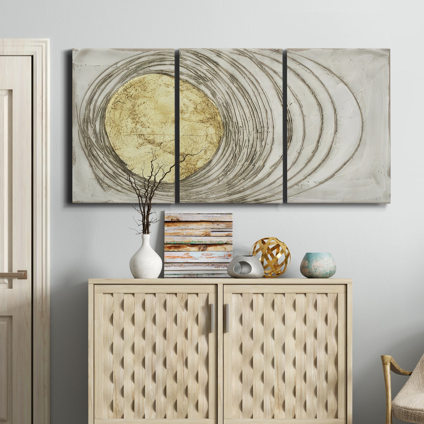 Three-panel canvas wall art featuring circular abstract energy forms, displayed above a cabinet in an entryway.