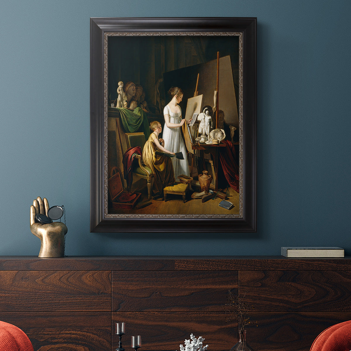 Classical interior painting of an artist at work by Louis-Leopold Boilly in an ornate black frame with gilded inner detail displayed in a dark-toned interior setting.