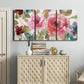 Three-panel canvas wall art featuring colorful floral watercolor composition, displayed above a cabinet in an entryway.