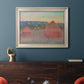 Impressionist haystack series landscape by Claude Monet in an ornate champagne frame displayed in a dark-toned interior setting.