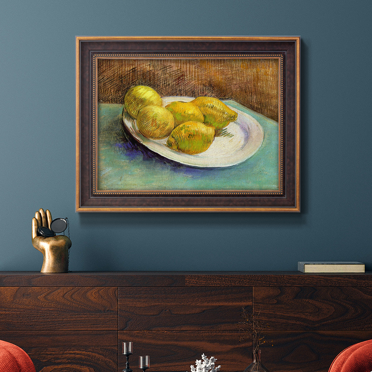 Impressionist still life with lemons by Vincent van Gogh in an ornate bronzed mahogany wood frame displayed in a dark-toned interior setting.