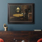 Impressionist domestic interior scene by Claude Monet in an ornate black frame with gilded inner detail displayed in a dark-toned interior setting.
