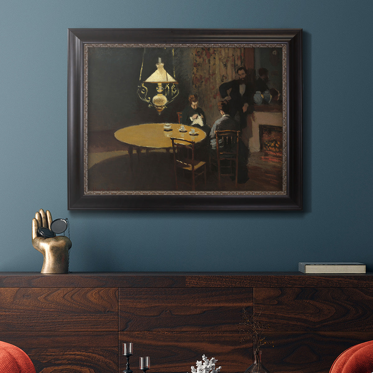 Impressionist domestic interior scene by Claude Monet in an ornate black frame with gilded inner detail displayed in a dark-toned interior setting.