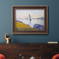 Impressionist coastal harbor at dusk by Paul Signac in an ornate bronzed mahogany wood frame displayed in a dark-toned interior setting.