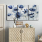 Three-panel canvas wall art featuring indigo floral blossoms awakening, displayed above a cabinet in an entryway.