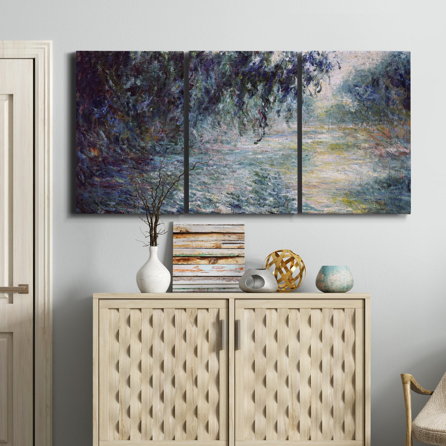 Three-panel canvas wall art featuring misty river scene in morning light, displayed above a cabinet in an entryway.