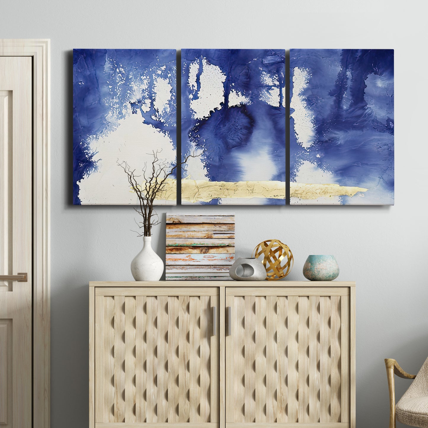 Three-panel canvas wall art featuring saturated abstract color fields, displayed above a cabinet in an entryway.