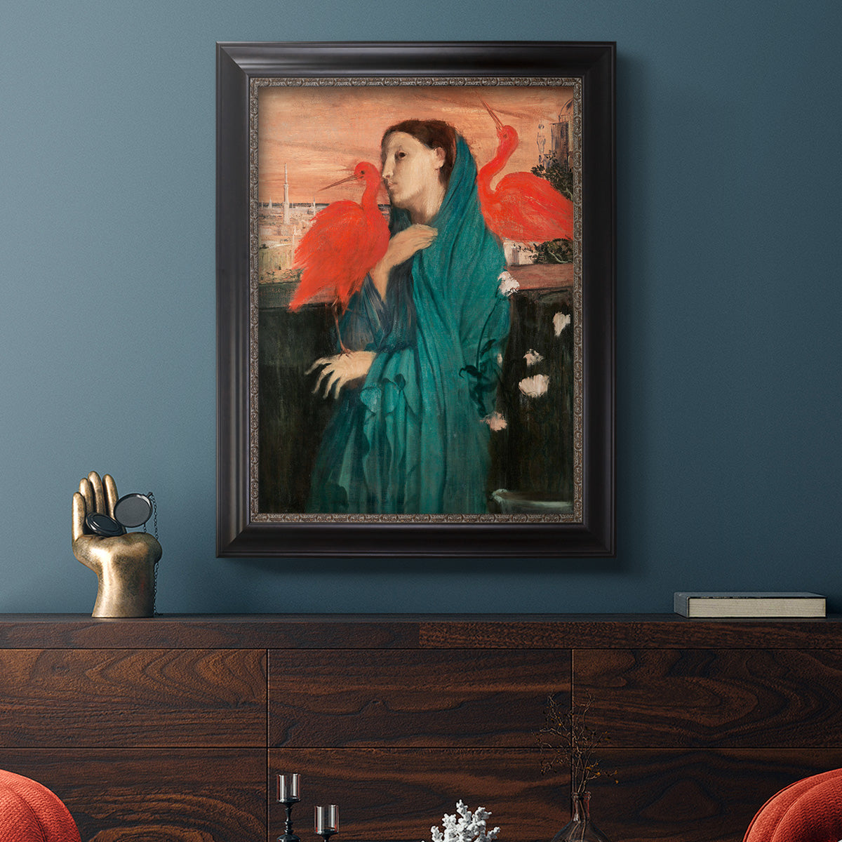 Impressionist portrait of a young woman with an ibis by Edgar Degas in an ornate black frame with gilded inner detail displayed in a dark-toned interior setting.