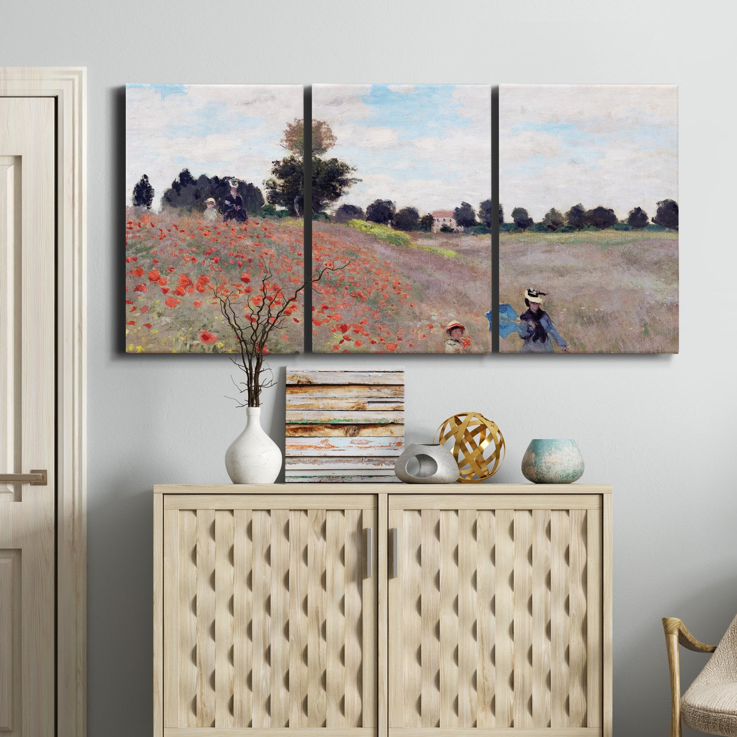 Three-panel canvas wall art featuring poppy field stretching across meadow, displayed above a cabinet in an entryway.