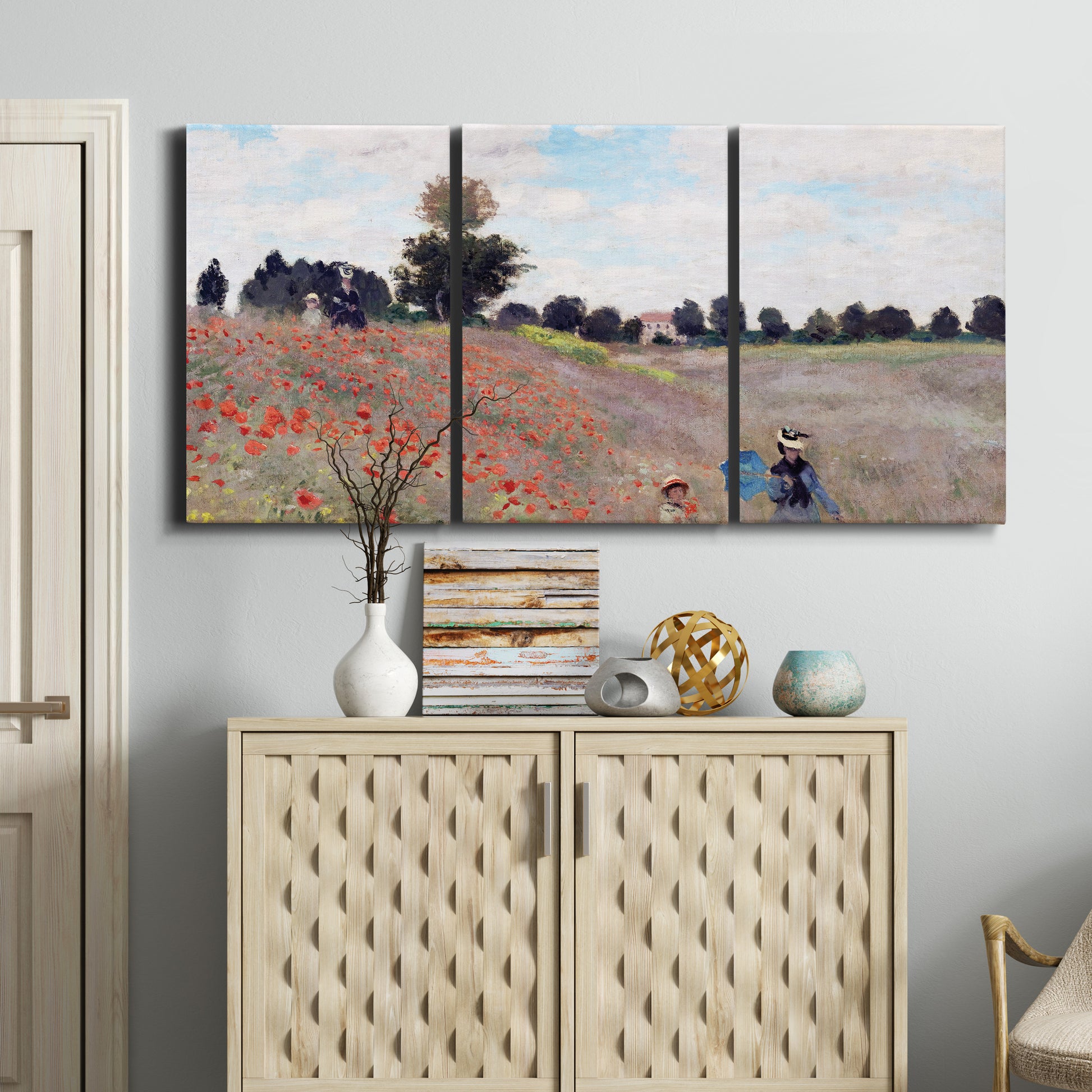 Three-panel canvas wall art featuring poppy field stretching across meadow, displayed above a cabinet in an entryway.