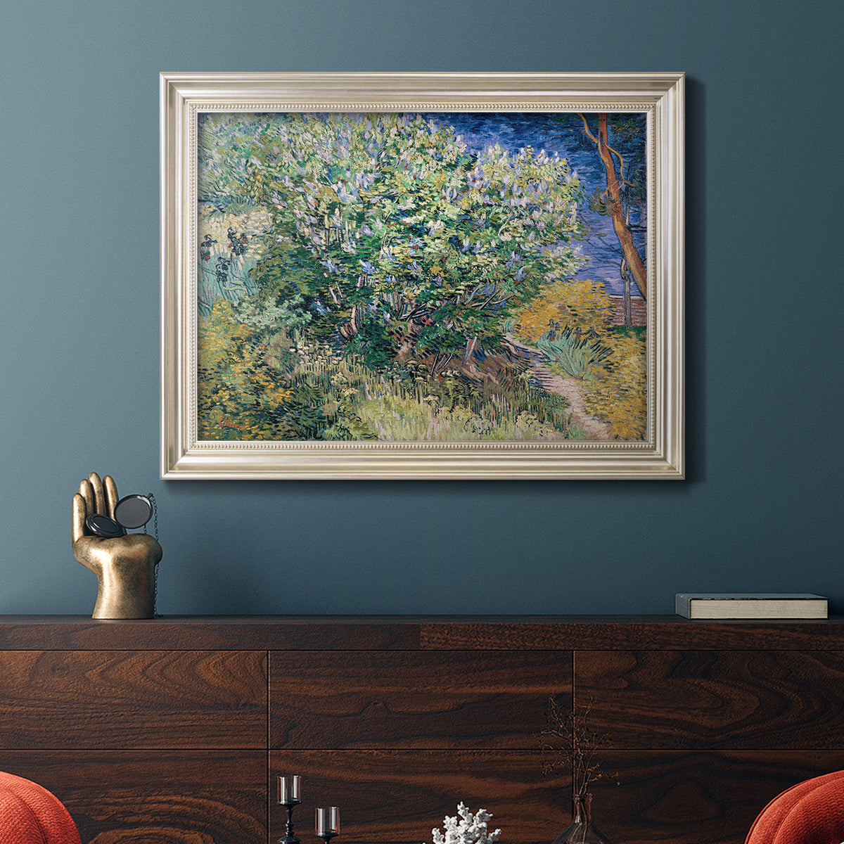 Impressionist lilac flower painting by Vincent van Gogh in an ornate champagne frame displayed in a dark-toned interior setting.