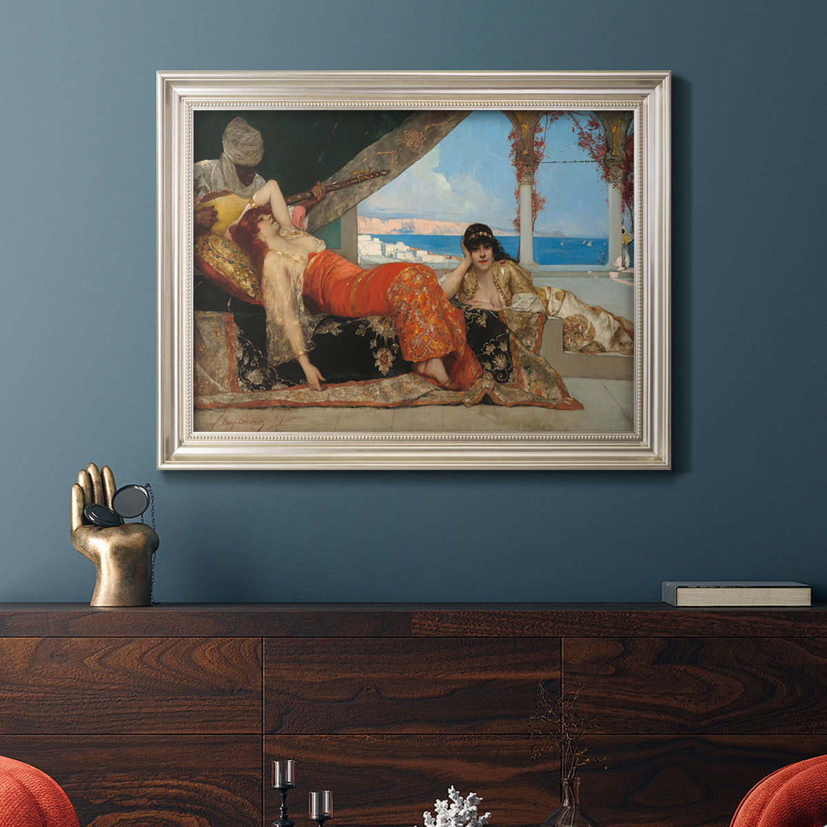 Orientalist portrait scene by Jean-Joseph Benjamin-Constant in an ornate champagne frame displayed in a dark-toned interior setting.