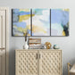 Three-panel canvas wall art featuring soft abstract spring watercolor tones, displayed above a cabinet in an entryway.