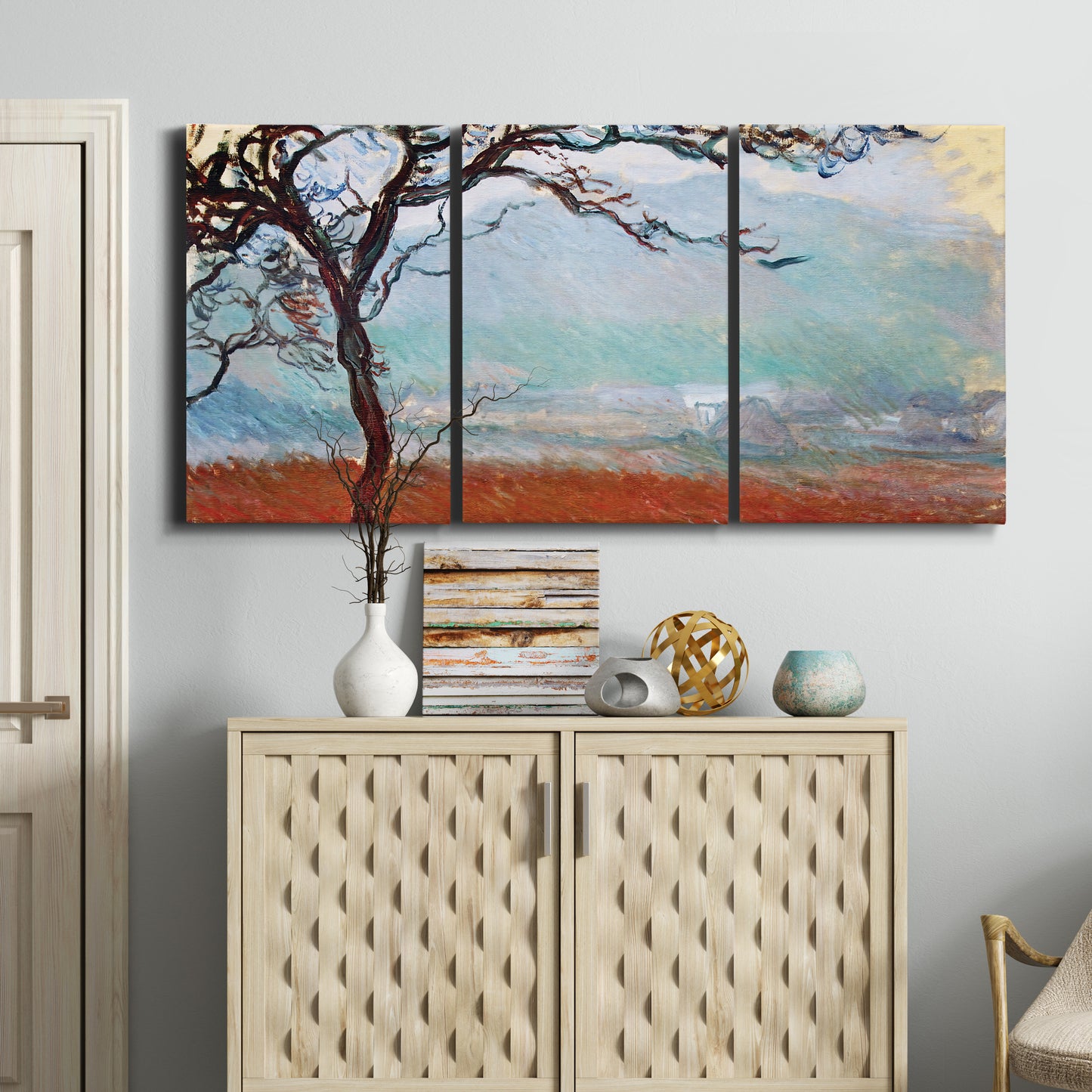 Three-panel canvas wall art featuring coastal trees at evening light, displayed above a cabinet in an entryway.