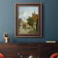 Rustic European street scene painting by Adriaan Eversen in an ornate bronzed mahogany wood frame displayed in a dark-toned interior setting.
