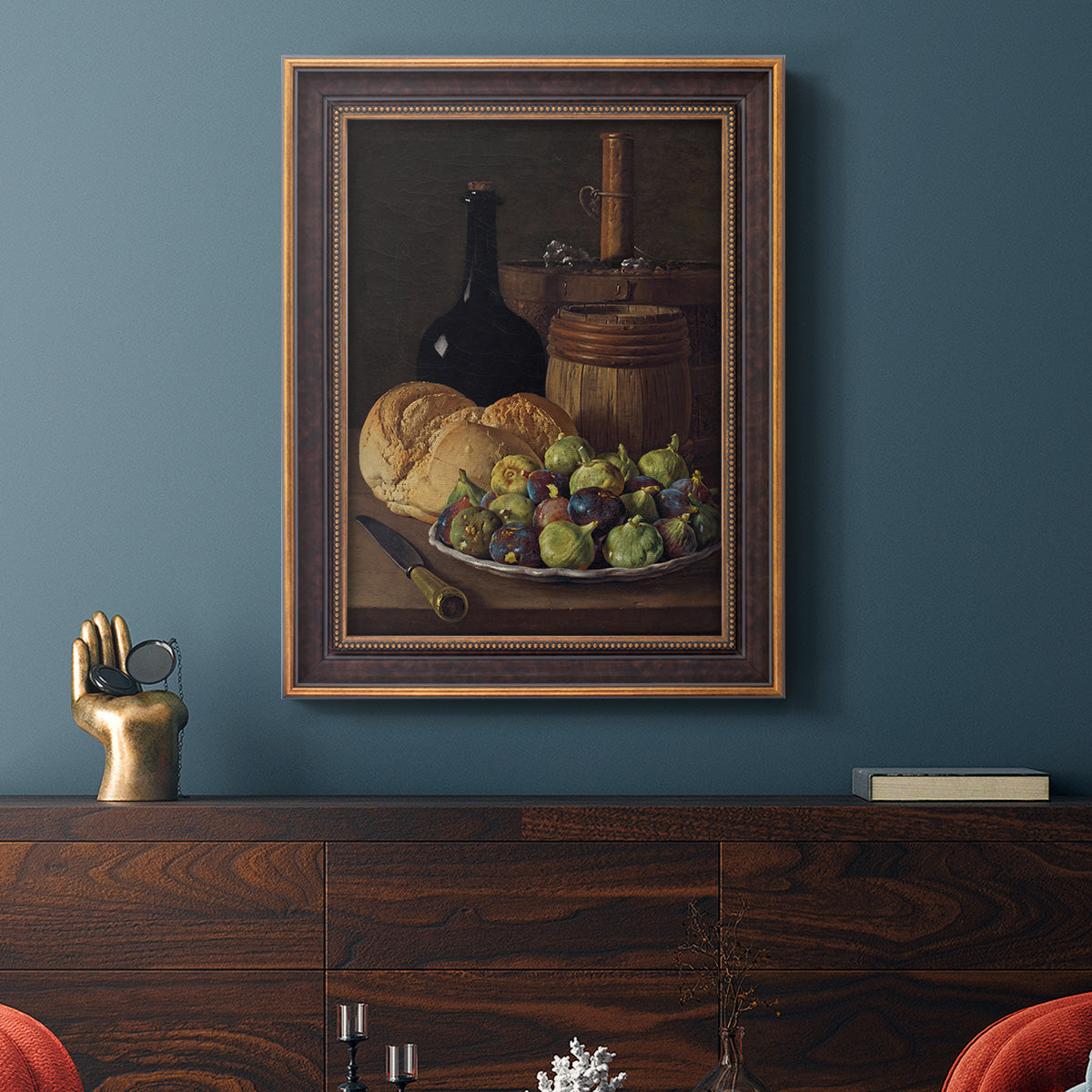 Realist still life with figs and bread by Luis Meléndez in an ornate bronzed mahogany wood frame displayed in a dark-toned interior setting.