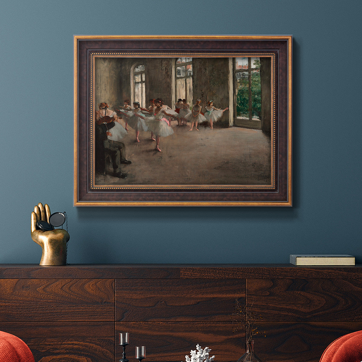 Early impressionist ballet rehearsal painting by Edgar Degas in an ornate bronzed mahogany wood frame displayed in a dark-toned interior setting.