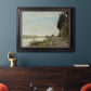 Impressionist river scene with red boats by Claude Monet in an ornate black frame with gilded inner detail displayed in a dark-toned interior setting.