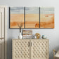 Three-panel canvas wall art featuring minimal horizon with soft blue tones, displayed above a cabinet in an entryway.