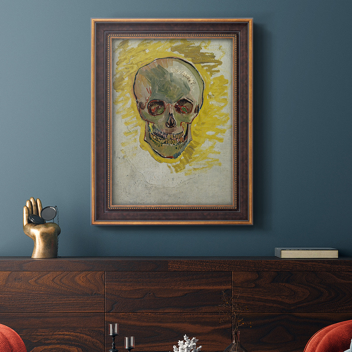 Expressive skull study painting by Vincent van Gogh in an ornate bronzed mahogany wood frame displayed in a dark-toned interior setting.