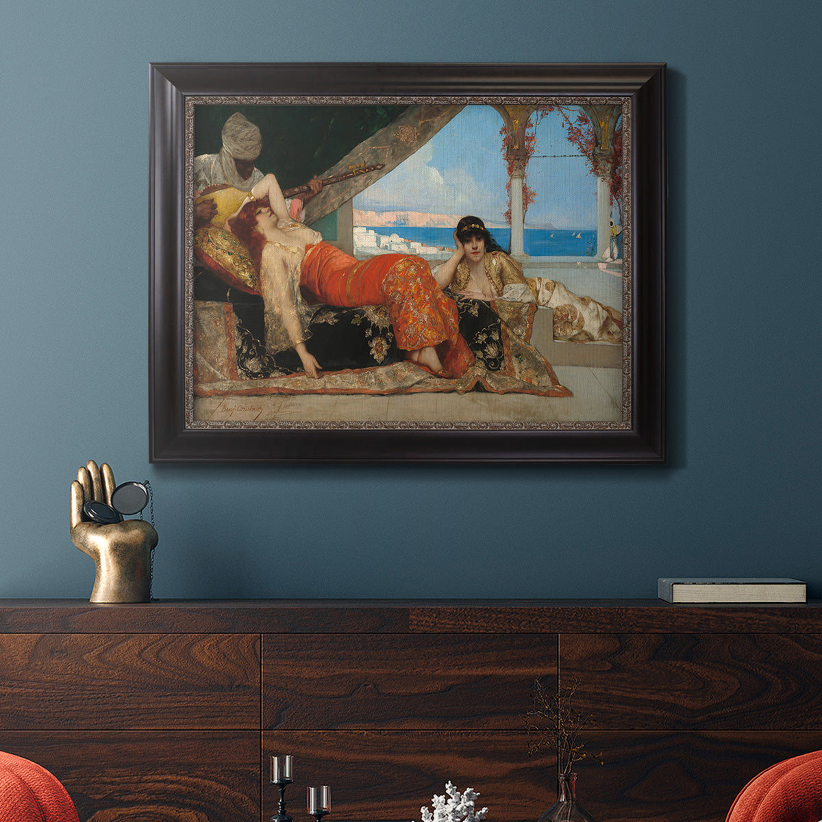 Orientalist portrait scene by Jean-Joseph Benjamin-Constant in an ornate black frame with gilded inner detail displayed in a dark-toned interior setting.