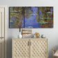 Three-panel canvas wall art featuring blue and purple water lily pond, displayed above a cabinet in an entryway.