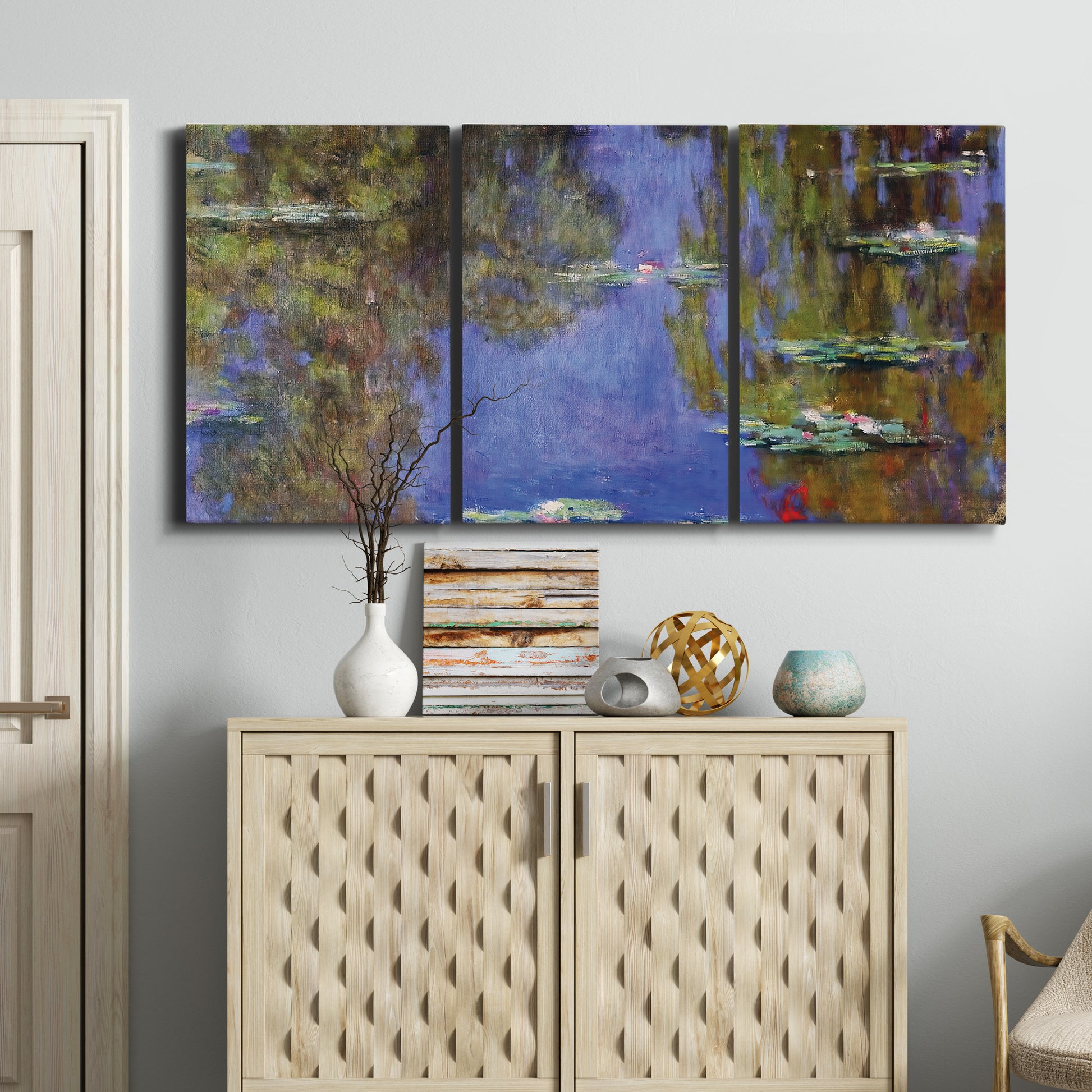 Three-panel canvas wall art featuring blue and purple water lily pond, displayed above a cabinet in an entryway.