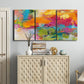 Three-panel canvas wall art featuring expressive abstract sunset tones, displayed above a cabinet in an entryway.